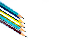 Few different colored wood pencil crayons arranged on a white background