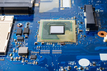 Close up of a printed blue computer circuit board.