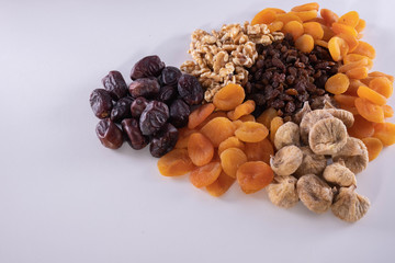 dried apricot, nuts, faygi, dates and raisins on a table