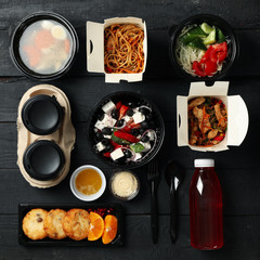 Flat lay with takeaway food on wooden background. Food delivery