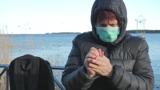 The lady wearing face mask and washing her hands in Finland
