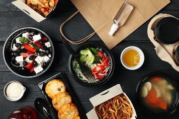 Food delivery. Food in takeaway boxes on wooden table