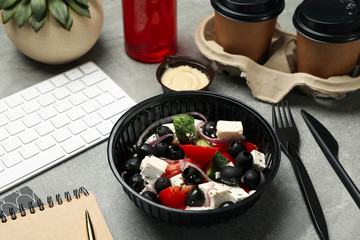 Food delivery. Food in takeaway box on gray background