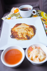 Photo of pupusas dish on couch with center console