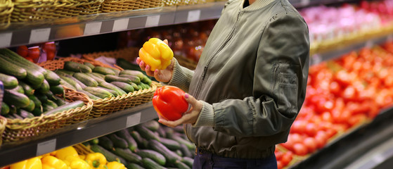 Woman buying vegetables at the market	