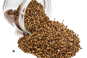 buckwheat in a glass jar on white. Close-up.