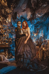 Fototapeta na wymiar Happy couple in Halloween Costume and Makeup. Bloody theme: the crazy maniak faces