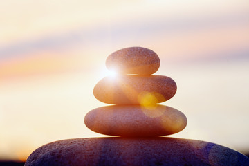 rock pebble pyramid, zen stones on sea beach, meditation, spa, harmony, calm background, balance concept