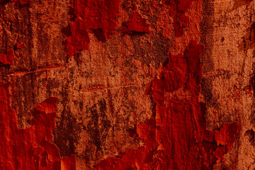 Red background old wall. Red old paint. Falling red paint