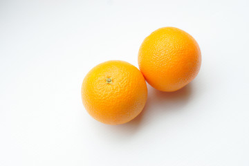 Two Oranges For Health Benefits On White Background.