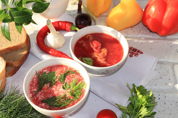 Traditional homemade borsch with egg and bread on a sunny table, place for text and menu, copy space. The concept of healthy and natural food, cooking dinner at home, selective focus.