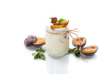 Homemade sweet yogurt with slices of ripe plums in a glass