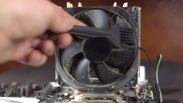 Dust pollution. Dirty cooler. Cleaning the cooler and processor heat sink from dust. Antistatic brush. 4k.