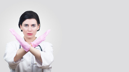 Female Doctor hands showing crossed stop sign. Doctor Wearing Gloves Stop coronavirus in fection,...