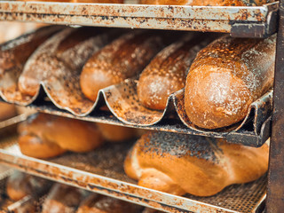 Freshly baked bread on trays in a self-catering supermarket.