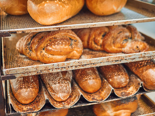 Freshly baked bread on trays in a self-catering supermarket.