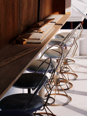 Weathered round bar stools with backrest and wooden table being demolished