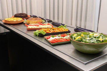 Lunch feast with different foods. Salads and desserts