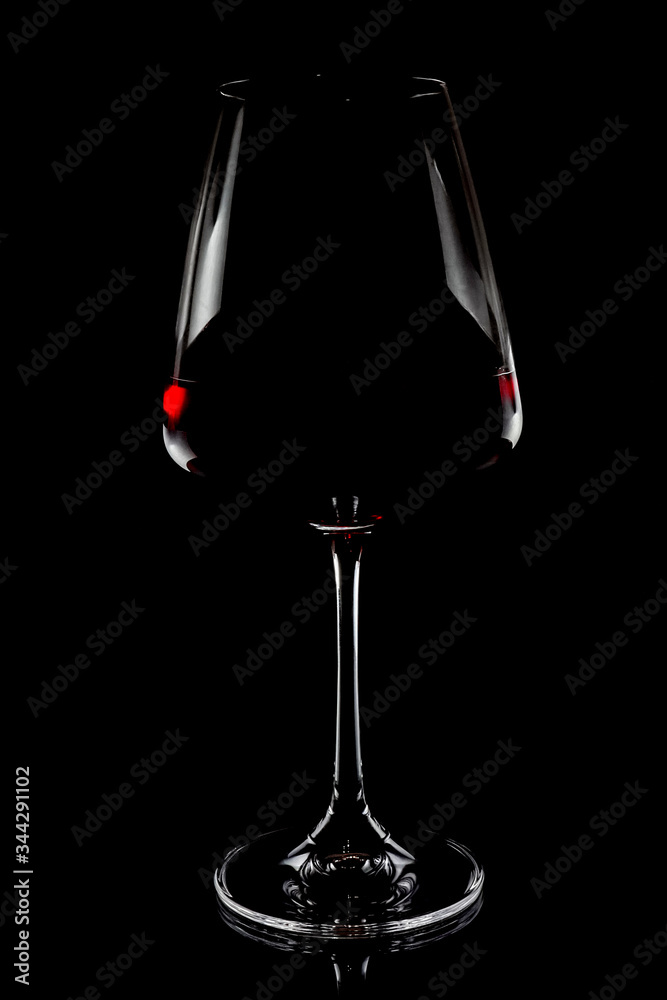 Wall mural wine glass on a black background