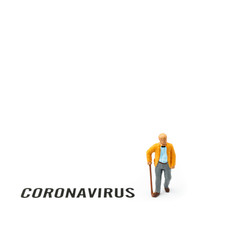 Old man and coronavirus outbreak. Small figurine and text about Coronavirus on white background.