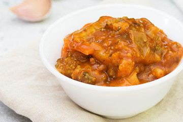 Vegetable mixture in a white bowl on a light table