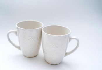 White circles with a pattern on a light background with ribbons and an angel