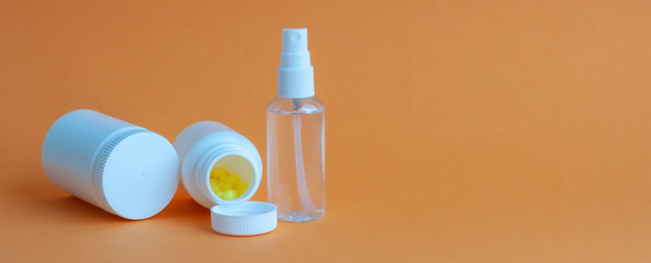 Close-up of three portable plastic bottles with tablets and vitamins and one transparent plastic...