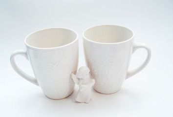 White circles with a pattern on a light background with ribbons and an angel