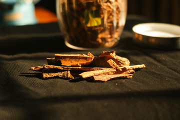 Cinnamon near its jar