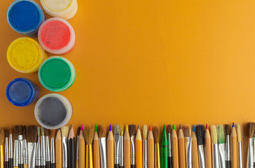 Colored pencils and brushes. gouache paint. view from above