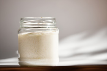 Yeast during fermentation closeup in a glass jar