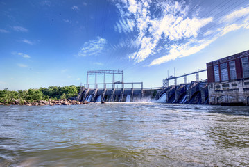 A large dam and hydroelectric plant on a beautiful spring day.
