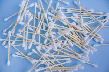 Top view on bamboo cotton sticks on blue background. Copyspace for your design, zero waste concept