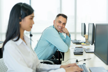 Happy operator working in the call center. Portrait of a technical support agent sitting at the office. Concept of Business telemarketing, Communication support. 