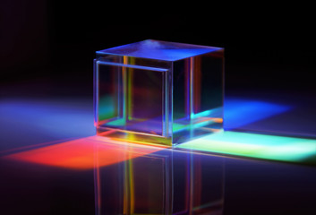 multicolored rays of light reflected by a crystal cube 