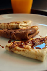 Selective focus. Delicious breakfast with pancakes, and orange juice on wooden tray