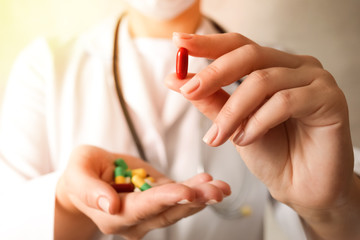 Medicine pills or capsules in hand, palm or fingers.