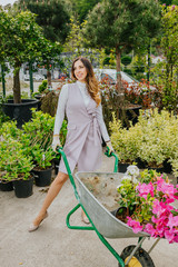 Young beautiful woman gardener enjoying the day at work. Space for text