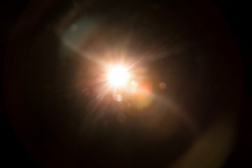 Abstract Natural Sun flare on the black background.