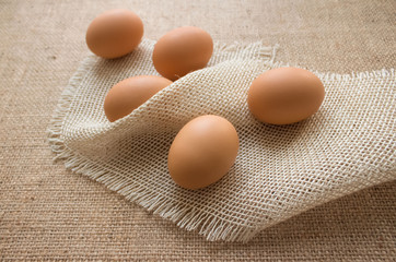 Close up of fresh organic chicken eggs from farmer market on linen tablecloth, selective focus