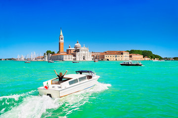Venice seascape. Giudecca Canal and San Giorgio Maggiore island, Italy, Europe. Motor boat with...