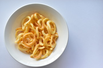 Plate with onion rings snacks on a white background