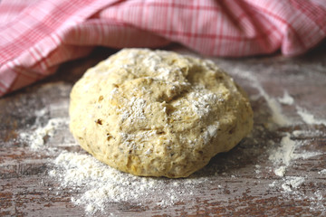 Selective focus. Macro. Yeast dough on the table. Dough for bread or pizza. Cooking at home. Baking at home.