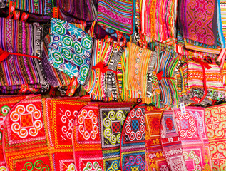 Display of multicolored ethnic fabrics with geometric shapes, Can Cau market, Vietnam
