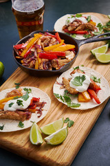 Mexican fajitas served on a wooden board on a table