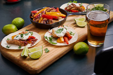Mexican fajitas served on a wooden board on a table