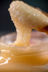 Jar of honey with wooden spoon on wooden board sweet cooking cuisine