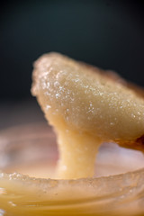 Jar of honey with wooden spoon on wooden board sweet cooking cuisine
