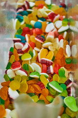 A variety of sweet candies in a store on the counter.