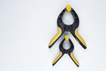 Fototapeta premium Two building clamps of different sizes above each other. View from above. Place for signature